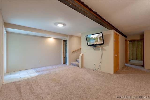 basement featuring light carpet