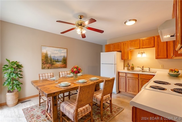 kitchen featuring ceiling fan, white appliances, sink, and range hood