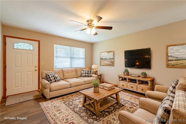 living room featuring hardwood / wood-style flooring and ceiling fan