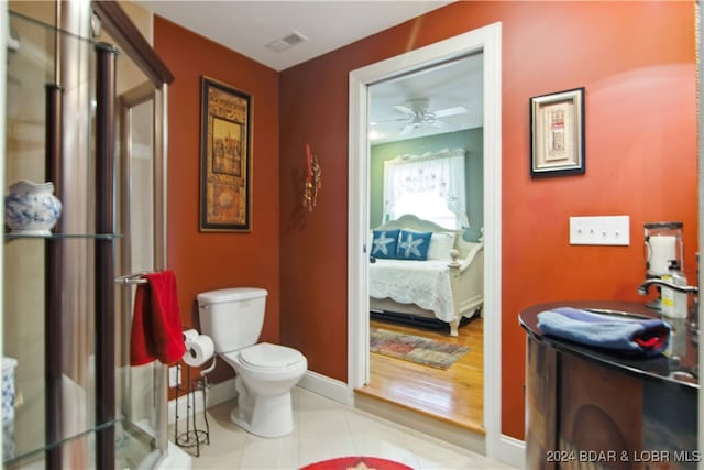 bathroom featuring ceiling fan, sink, toilet, and wood-type flooring