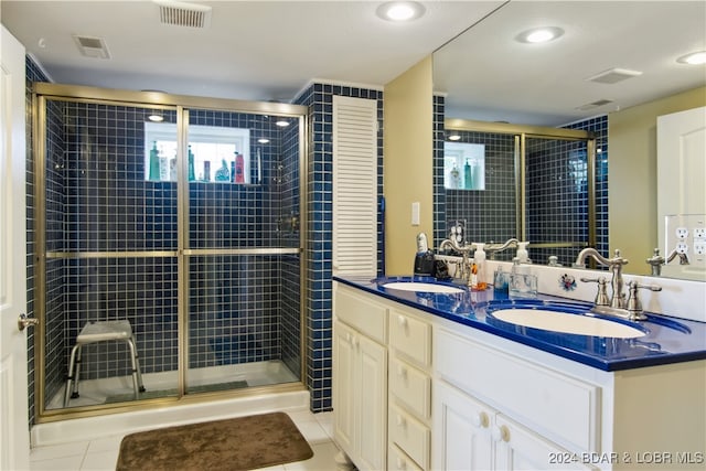 bathroom featuring vanity, an enclosed shower, and tile patterned floors