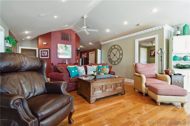 living room featuring light hardwood / wood-style floors, lofted ceiling, and ceiling fan