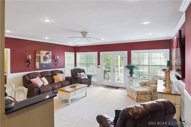 carpeted living room featuring french doors, ornamental molding, and ceiling fan