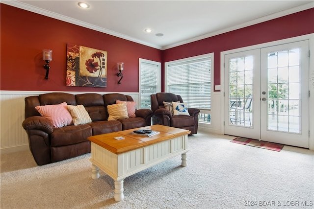 carpeted living room with french doors and crown molding