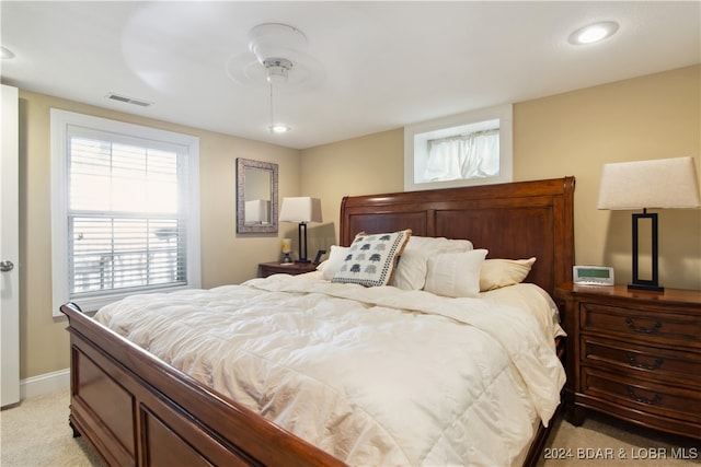 bedroom featuring ceiling fan and light carpet