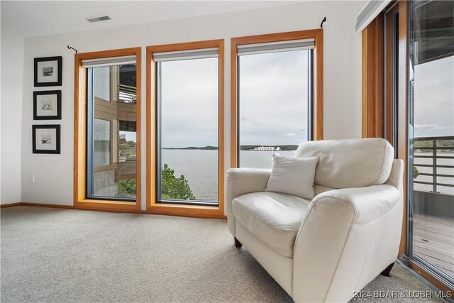 701 Cedar Rd Unit 1B, Lake Ozark, MO 65049 - sitting room with baseboards, a water view, carpet flooring, and visible vents