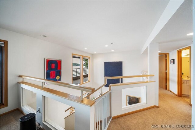 701 Cedar Rd Unit 1B, Lake Ozark, MO 65049 - hall with carpet floors, baseboards, recessed lighting, and an upstairs landing