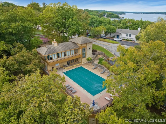 view of swimming pool with a patio and a water view