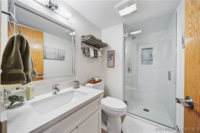 bathroom with vanity, toilet, and an enclosed shower