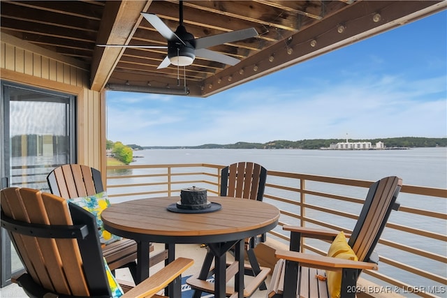 view of patio with ceiling fan and a water view