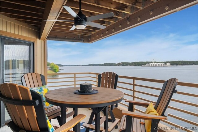 701 Cedar Rd Unit 1B, Lake Ozark, MO 65049 - balcony with outdoor dining area, a ceiling fan, and a water view