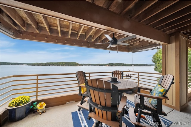 view of patio / terrace featuring a water view, ceiling fan, and a balcony