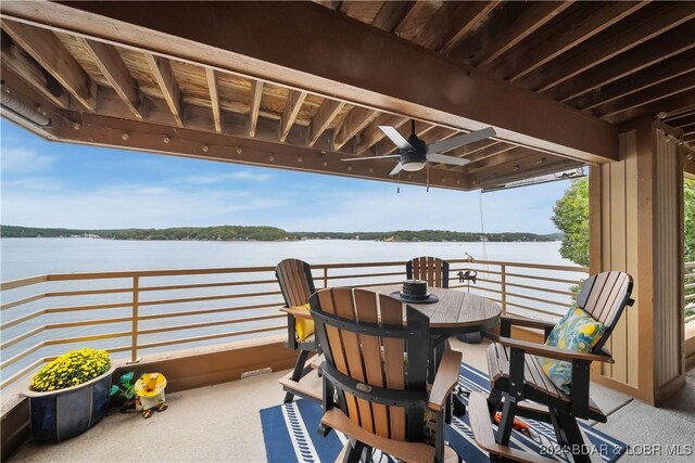 701 Cedar Rd Unit 1B, Lake Ozark, MO 65049 - view of patio with a water view, ceiling fan, and outdoor dining space
