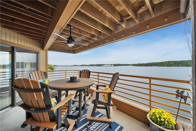 exterior space with a water view and ceiling fan