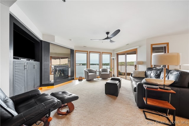 living room featuring ceiling fan and carpet flooring