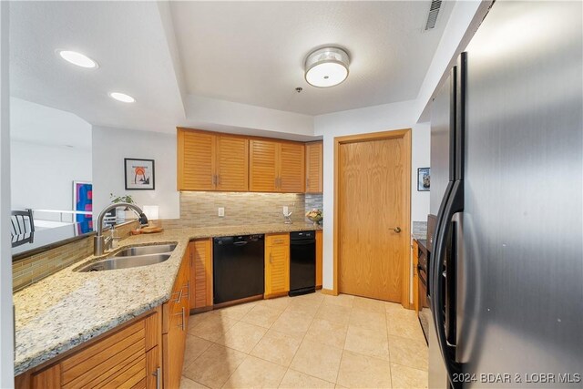 701 Cedar Rd Unit 1B, Lake Ozark, MO 65049 - kitchen with light stone counters, a sink, a peninsula, tasteful backsplash, and black appliances