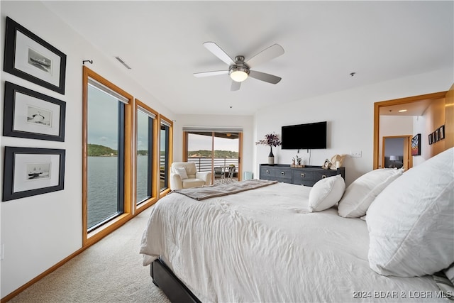 bedroom with ceiling fan, access to exterior, and carpet flooring