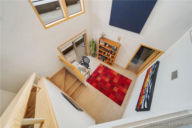 701 Cedar Rd Unit 1B, Lake Ozark, MO 65049 - staircase featuring a high ceiling and visible vents