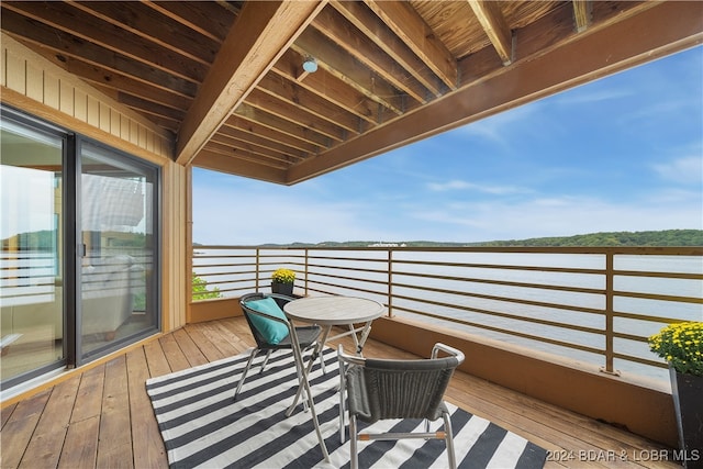 wooden terrace featuring a water view