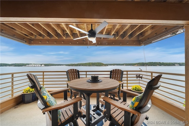 exterior space with a water view and ceiling fan