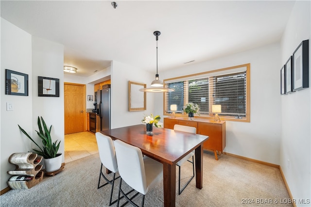 dining room featuring light carpet