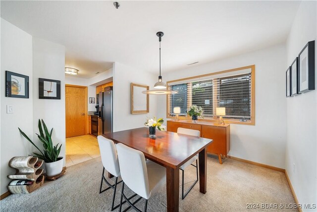 701 Cedar Rd Unit 1B, Lake Ozark, MO 65049 - dining area with baseboards and light colored carpet