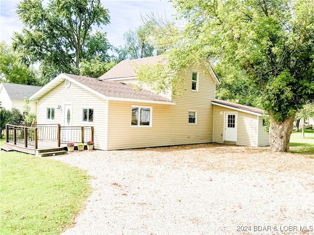 exterior space featuring a lawn and a wooden deck