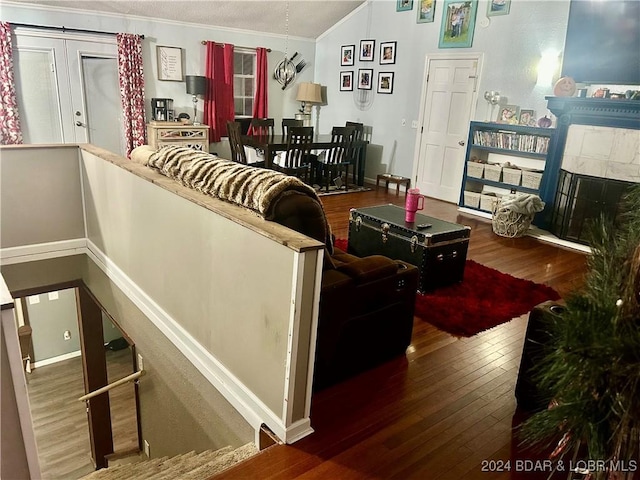 living room with hardwood / wood-style floors and ornamental molding