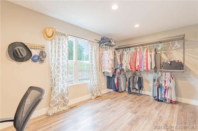 walk in closet with wood-type flooring