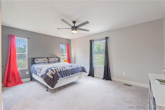 carpeted bedroom with ceiling fan