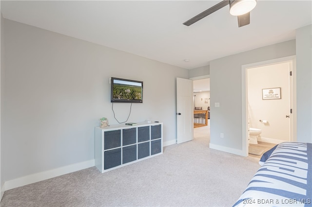 carpeted bedroom featuring ceiling fan and connected bathroom