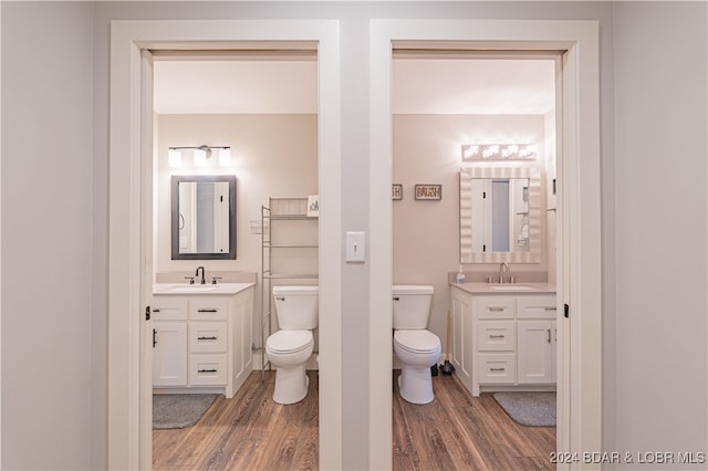 bathroom with vanity, hardwood / wood-style floors, and toilet