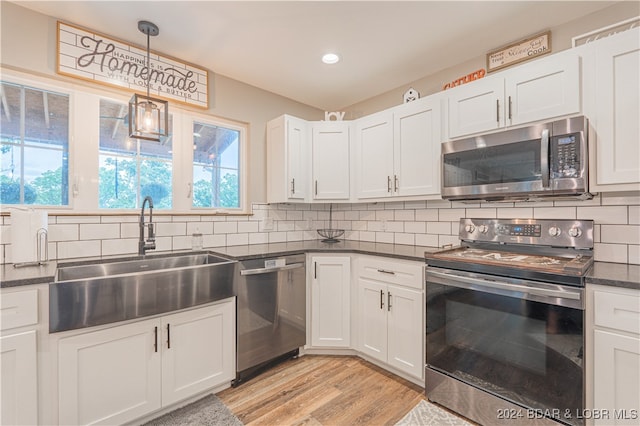 kitchen with white cabinetry, sink, and stainless steel appliances