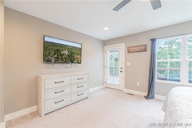 bedroom with ceiling fan, light colored carpet, and access to exterior