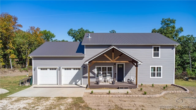 view of front property with covered porch and a garage