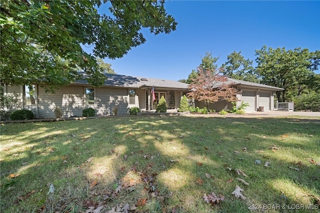 ranch-style home with a garage and a front yard