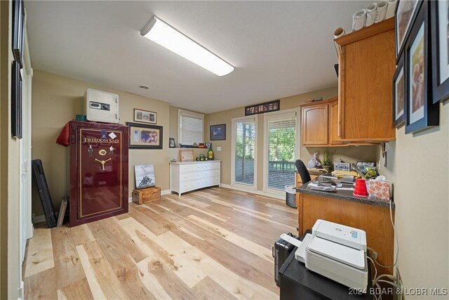 home office with light wood-type flooring and baseboards