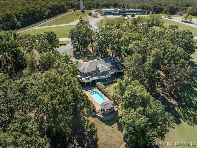 birds eye view of property featuring a view of trees