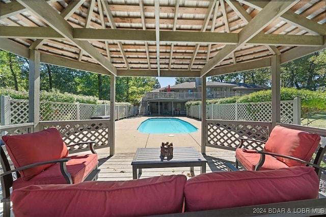 view of pool with fence, outdoor lounge area, a fenced in pool, and a patio