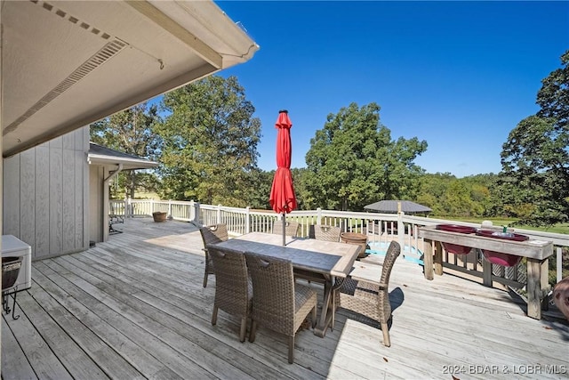 wooden deck featuring outdoor dining area
