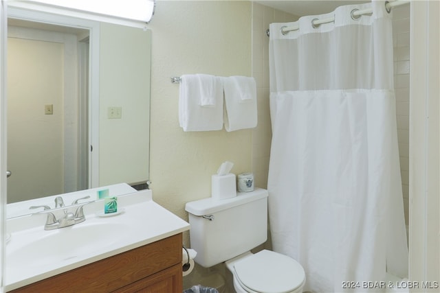 bathroom featuring vanity, toilet, and a shower with shower curtain