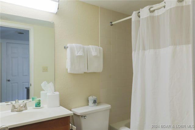 full bathroom with shower / bath combo, vanity, and toilet