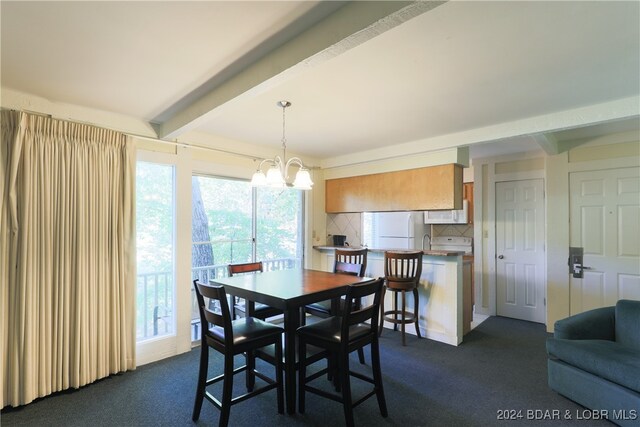 carpeted dining area with a notable chandelier, sink, and beam ceiling