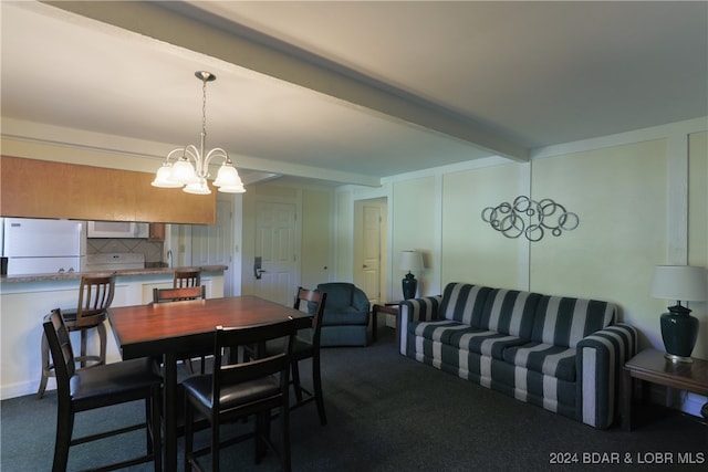 carpeted dining space with beamed ceiling and a chandelier