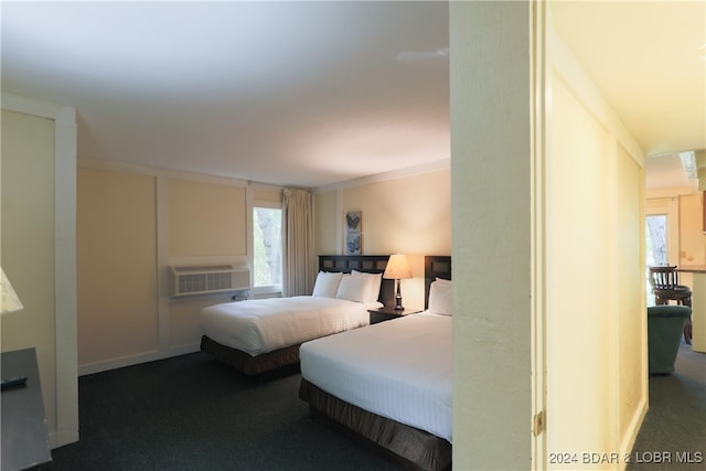 bedroom with dark carpet and crown molding