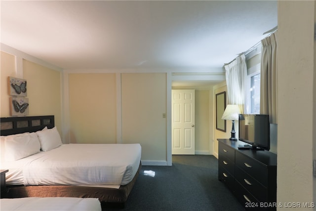 bedroom with dark colored carpet