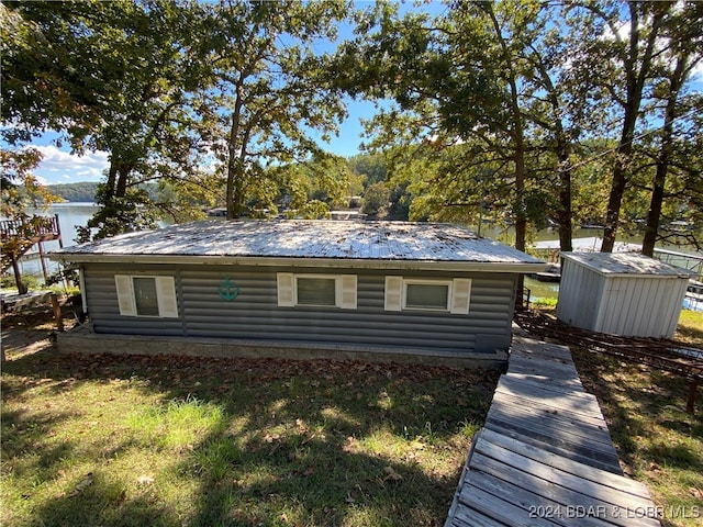 exterior space with a lawn and a shed