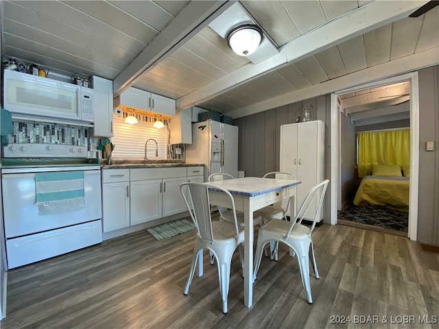 interior space featuring dark wood-type flooring, sink, beam ceiling, white cabinetry, and white appliances