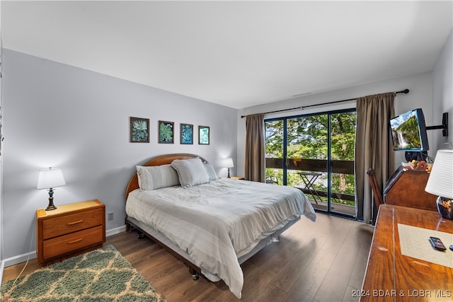 bedroom with dark hardwood / wood-style floors and access to exterior