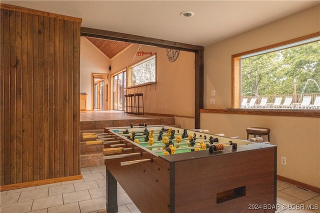 playroom with lofted ceiling with beams and light tile patterned floors